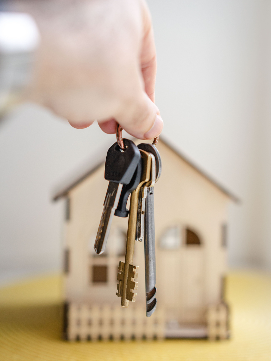 Agent handing over keys to a new property owner